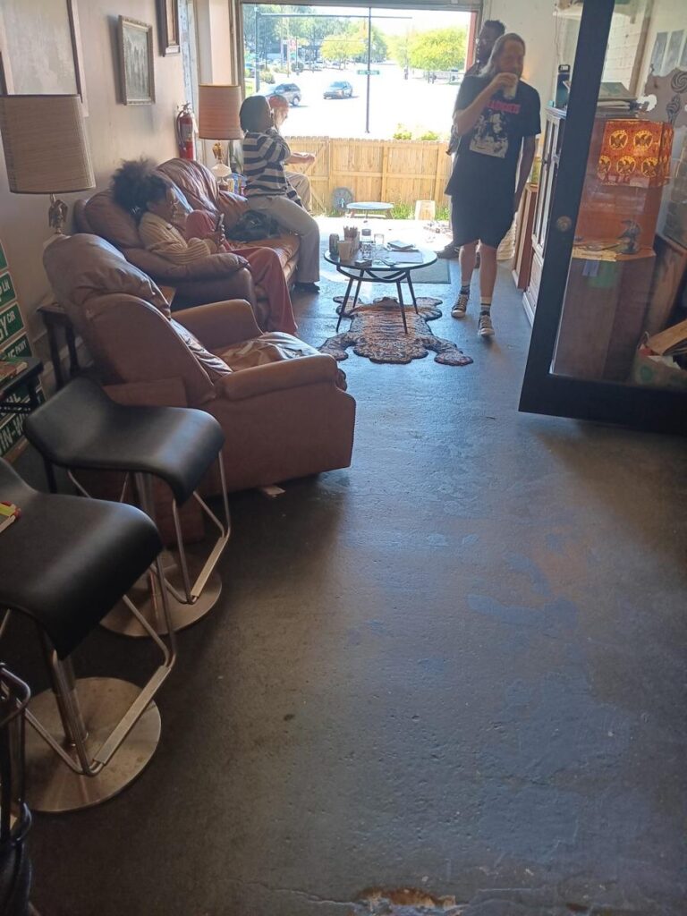 People relaxing in armchairs in a bright lounge during the day