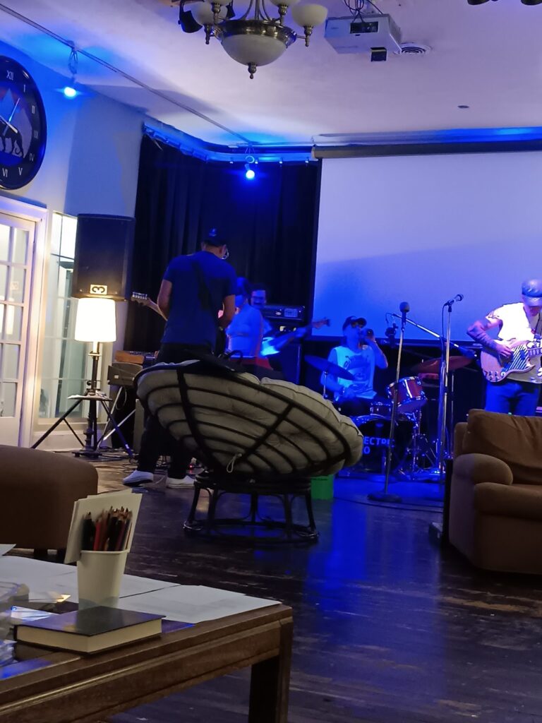 Musicians play an evening set under blue light