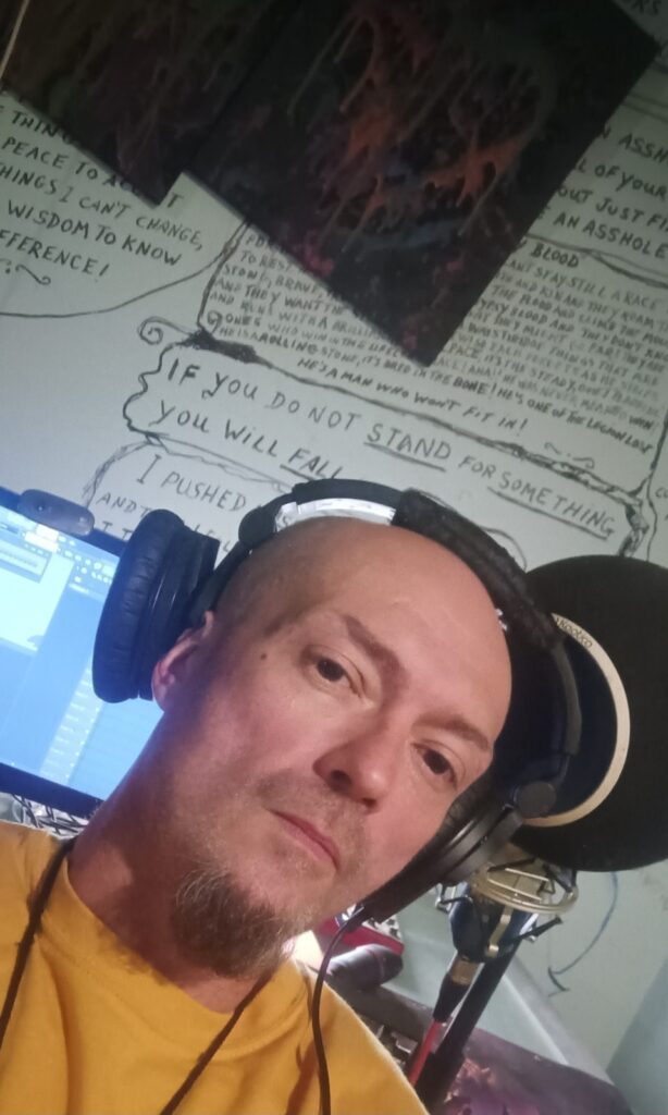 Second Chance Village founder Ryan Scanlon records vocals in headphones