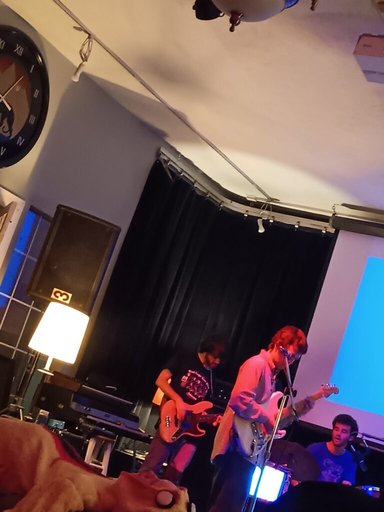 Two guitarists play side by side during a Second Chance Village live music night