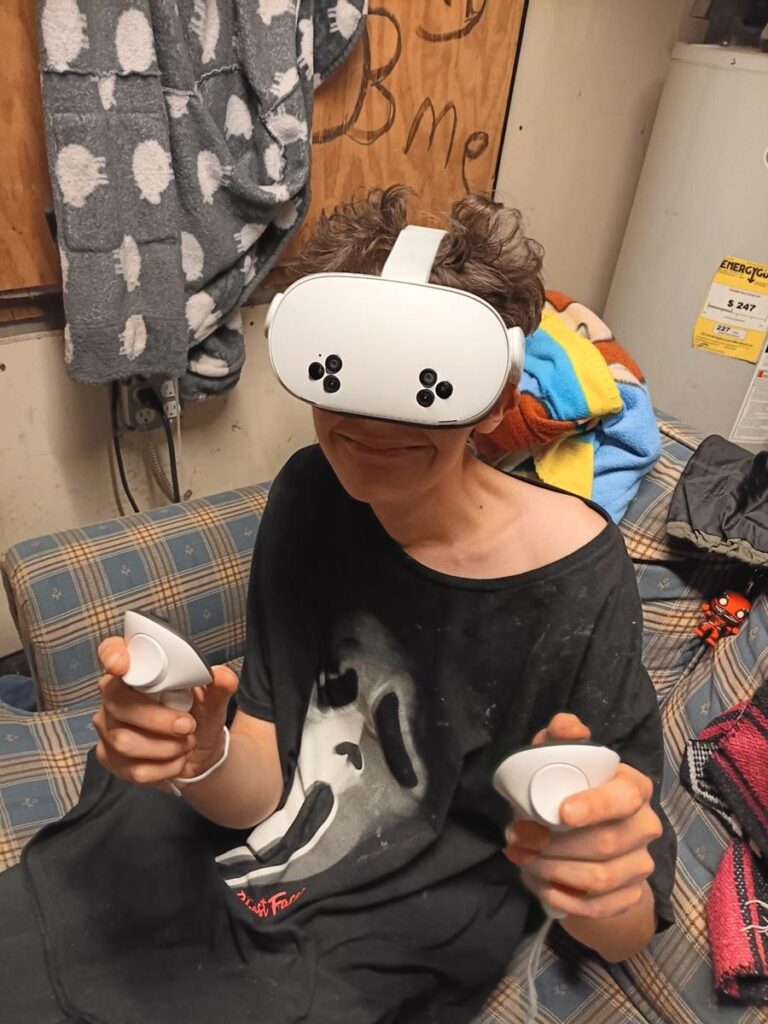 A member tries a virtual reality headset and controllers